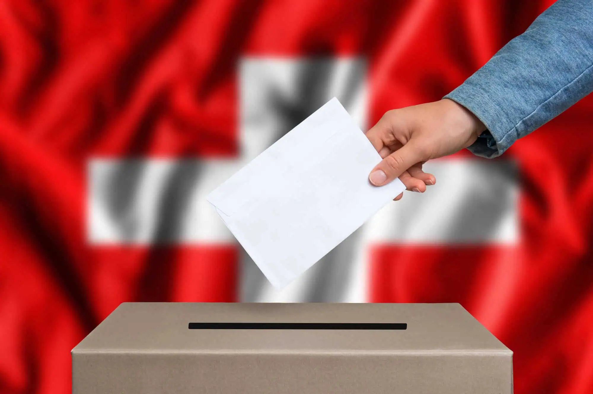 Hand holding passport over flag background